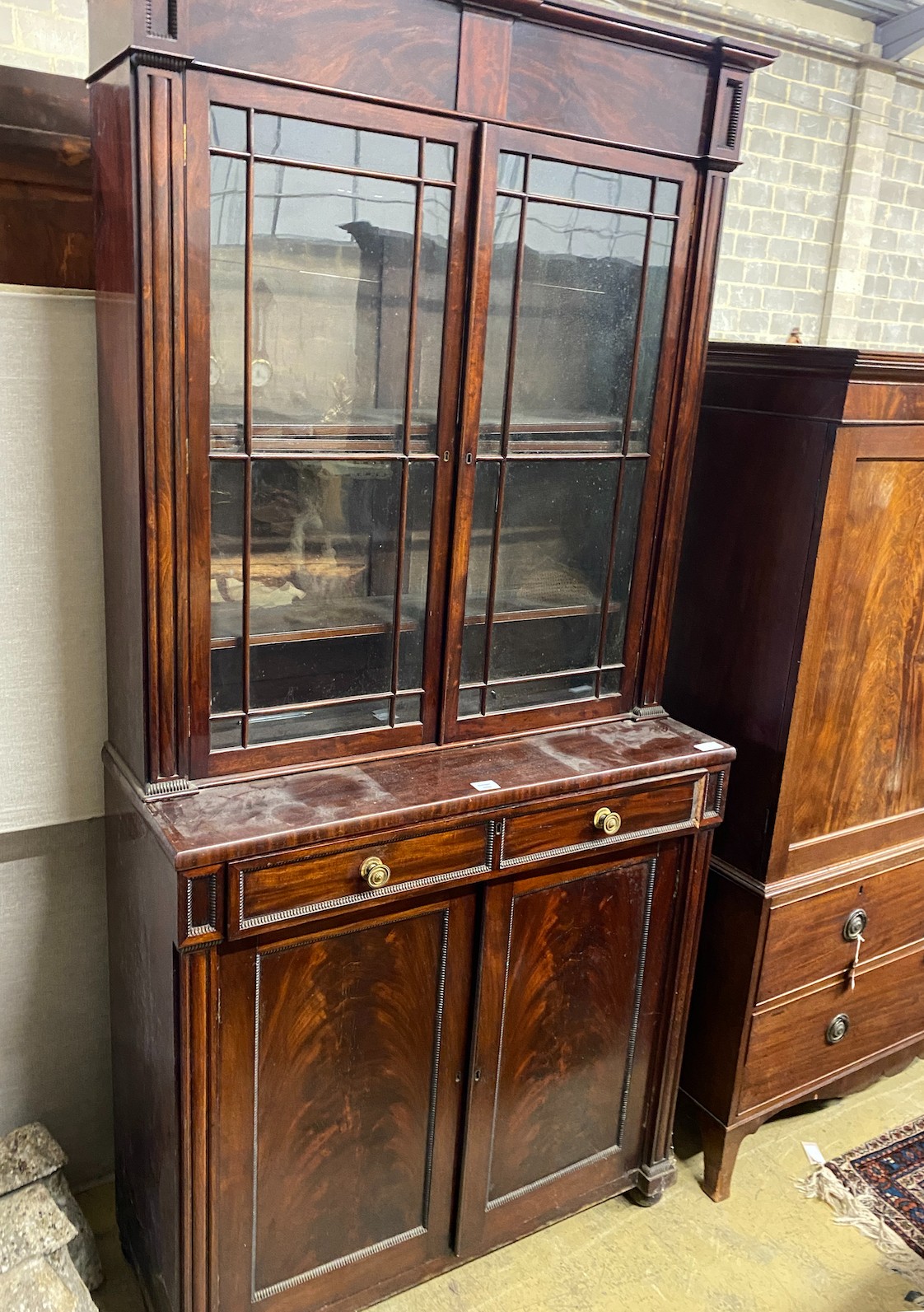 A Regency mahogany bookcase / cupboard, width 106cm, depth 44cm, height 226cm